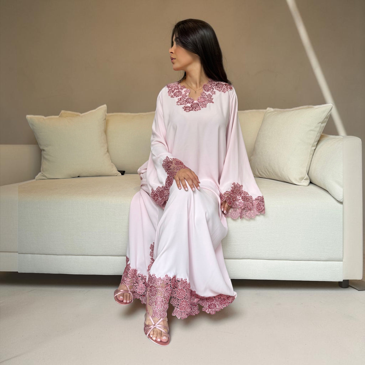 ABAYAS dusty rose lace dress in soft blush pink Nida fabric with floral lace trim on neckline, sleeves, and hem. Elegant occasion wear.
