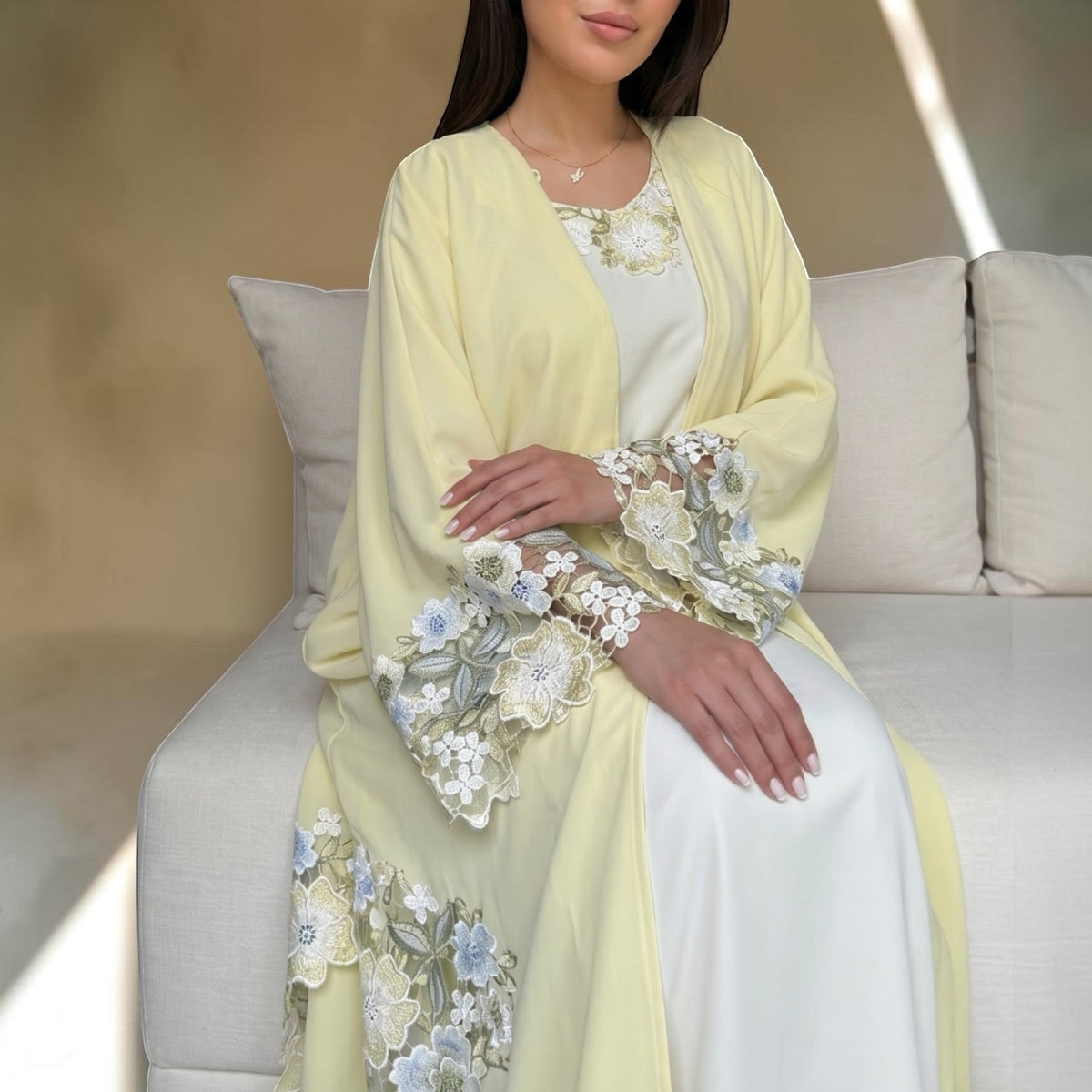 ABAYAS yellow Nida Abaya Mimosa with white inner dress, featuring floral lace on sleeves and hem.